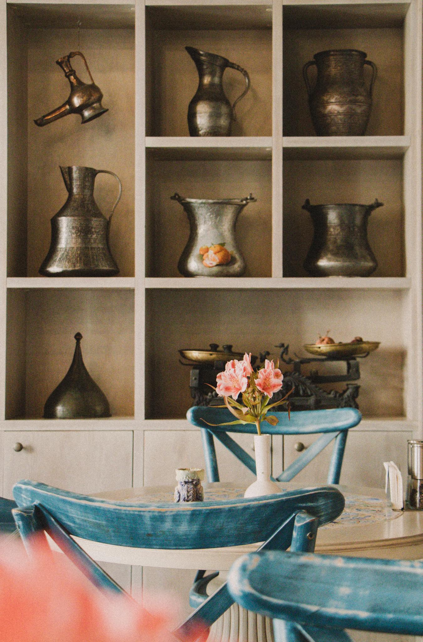 Capture the charm of a vintage café with antique jugs and cozy atmosphere.